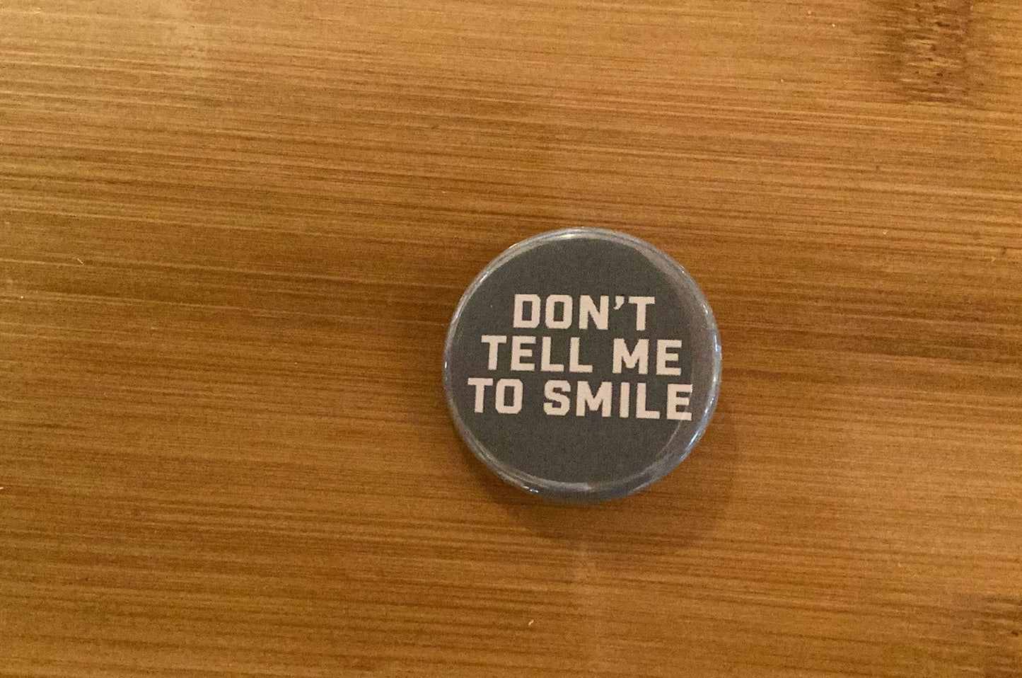 “Don’t Tell Me to Smile” Pin - Agricola Street Books