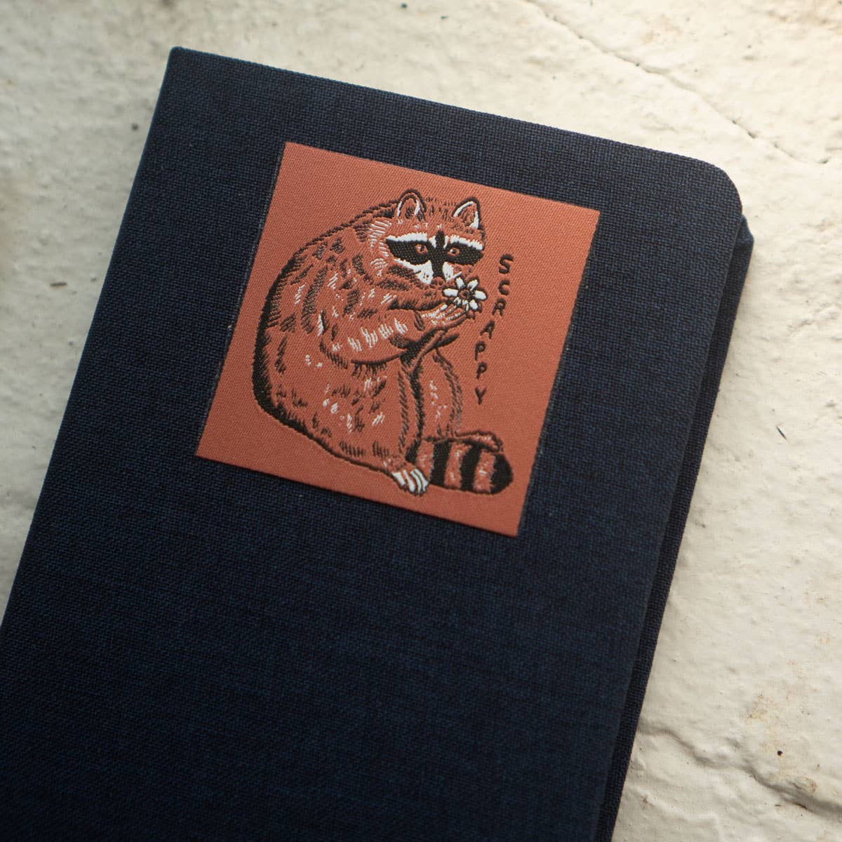 Stay Home Club - Patched Linen Notebook - Scrappy Raccoon