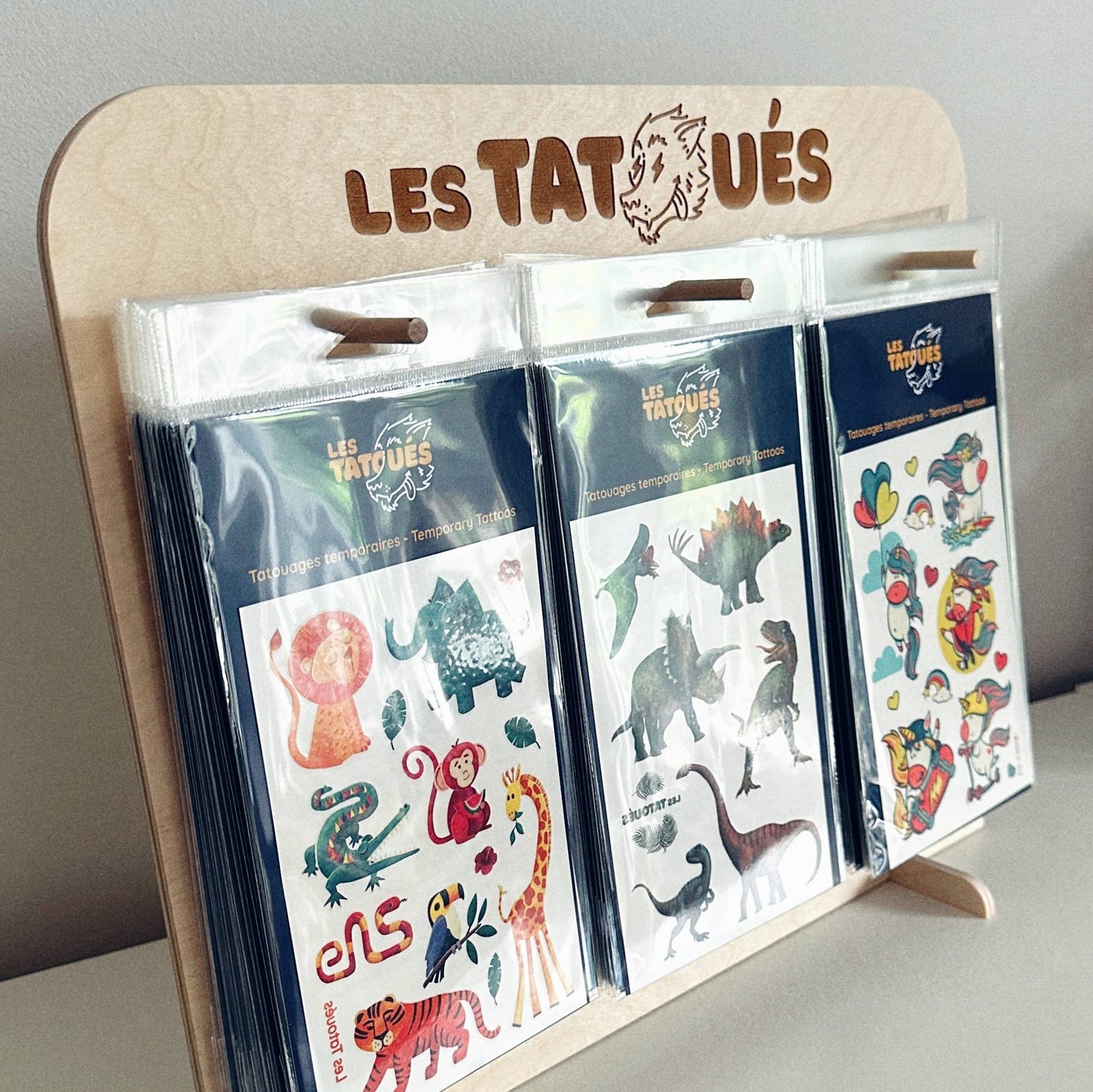 Les Tatoués - Our wood display. - Agricola Street Books